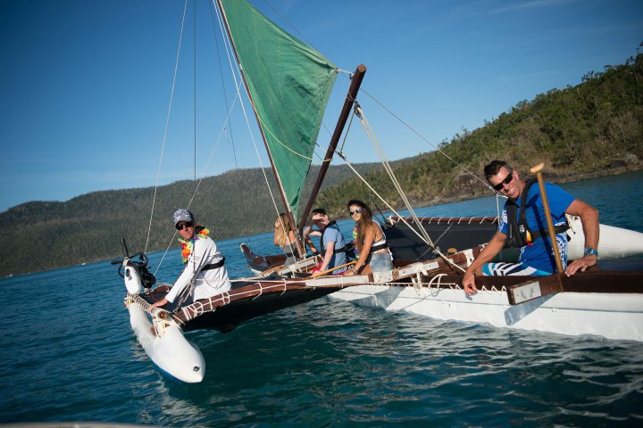 a group of people riding on the back of a ohana